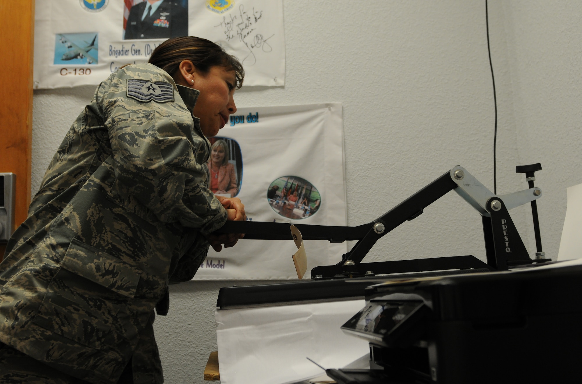 Tech. Sgt. Sally Stevenson, Airman and Family Readiness Center readiness NCO, irons a photo onto a pillow case Feb. 29, 2016, Keesler Air Force Base, Miss. The pillow case program is one of several services available to families with deployed members, and allows children to receive pillow cases with photos of their deployed parent as a way to stay connected during the time apart. (U.S. Air Force photo by Senior Airman Holly Mansfield)