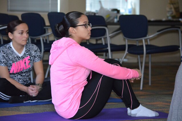 Lance Cpl. Yemili Maldonado listens to a yoga instructor while participating in a women’s group session in the Headquarters and Service Battalion classroom on February 17. 