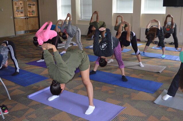 Women participate in a yoga session on February 17 in the Headquarters and Service Battalion classroom as part of a weekly women’s group meeting.
