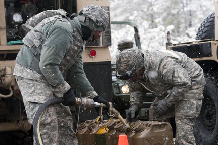 Spc. Brian Bikar (left) and Spc. Caleb Mitchell (right), petroleum supply specialists with the 957th Quartermaster Company (petroleum supply), fill fuel cans during Combat Sustainment Support Exercise 78-16-01 at Joint Base McGuire-Dix-Lakehurst, N.J., March 4, 2016. CSTX 78-16-01 is a U.S. Army Reserve exercise conducted at multiple locations across the country designed to challenge combat support units and Soldiers to improve and sustain the skills necessary during a deployment. (U.S. Army photo by Sgt. Christopher Bigelow/Released)