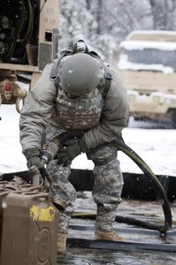 Spc. Roddgrev Walter, a petroleum supply specialist with the 957 Quartermaster Company (petroleum supply), fills fuel cans during Combat Sustainment Support Exercise 78-16-01 at Joint Base McGuire-Dix-Lakehurst, N.J., March 4, 2016. CSTX 78-16-01 is a U.S. Army Reserve exercise conducted at multiple locations across the country designed to challenge combat support units and Soldiers to improve and sustain the skills necessary during a deployment. (U.S. Army photo by Sgt. Christopher Bigelow/Released)