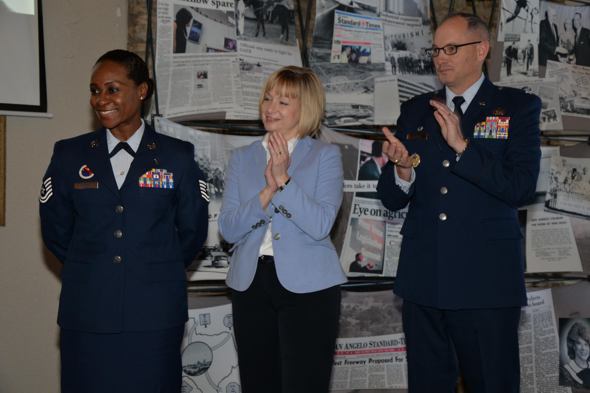 Toni L. Hansen, 17th Force Support Squadron Director, and U.S. Air Force Col. Michael L. Downs, 17th Training Wing Commander, congratulate Tech. Sgt. Curtrell L. Gibson, 17th FSS Airman Leadership School instructor, for receiving the Order of Merit during the Chamber of Commerce luncheon at the Bentwood Country Club in San Angelo, Texas, March 9, 2016. The Order of Merit is awarded for outstanding service to country and community. (U.S. Air Force photo by Airman 1st Class Randall A. S. Moose/Released)  