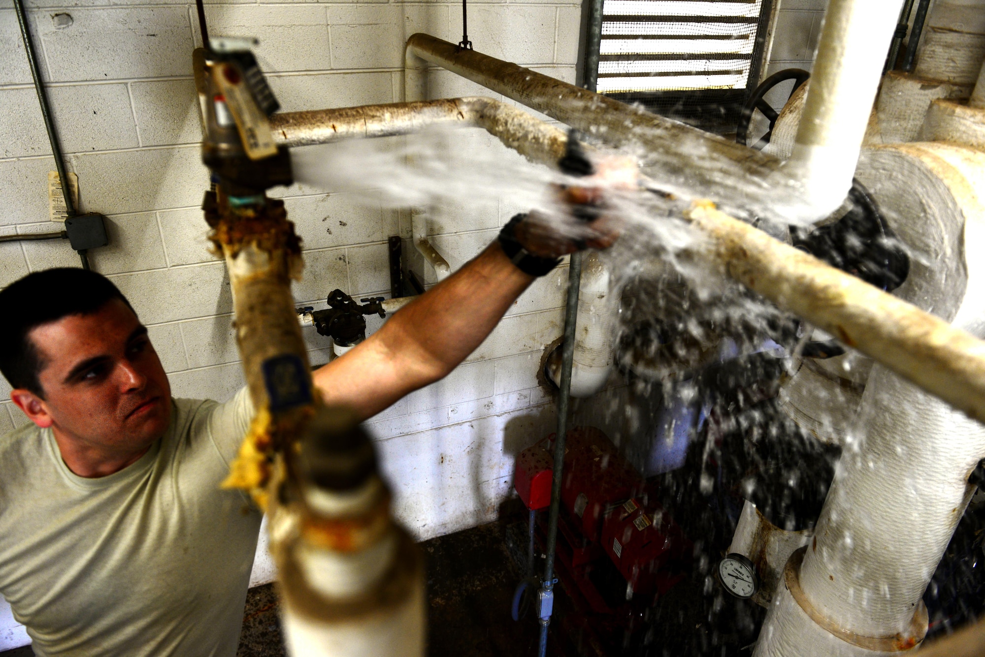 Senior Airman Sean Easton, 2nd Civil Engineer Squadron heating ventilation and air conditioning systems technician, tests a fill line to an HVAC system for the dorms at Barksdale Air Force Base, La., March 7, 2016. HVAC Airmen got a jump start on prepping Barksdale HVAC systems this year before summer heat moves in. (U.S. Air Force Photo/Airman 1st Class Luke Hill)