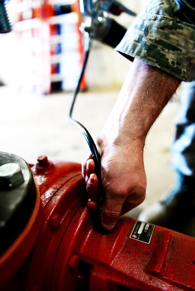 Senior Airman Troy Adams, 2nd Civil Engineer Squadron heating ventilation and air conditioning systems technician, greases an HVAC system pump at Barksdale Air Force Base, La., March 7, 2016. HVAC Airmen worked on refrigerators at Barksdale’s dining facilities and made sure pipes were properly drained during winter. (U.S. Air Force Photo/Airman 1st Class Luke Hill)