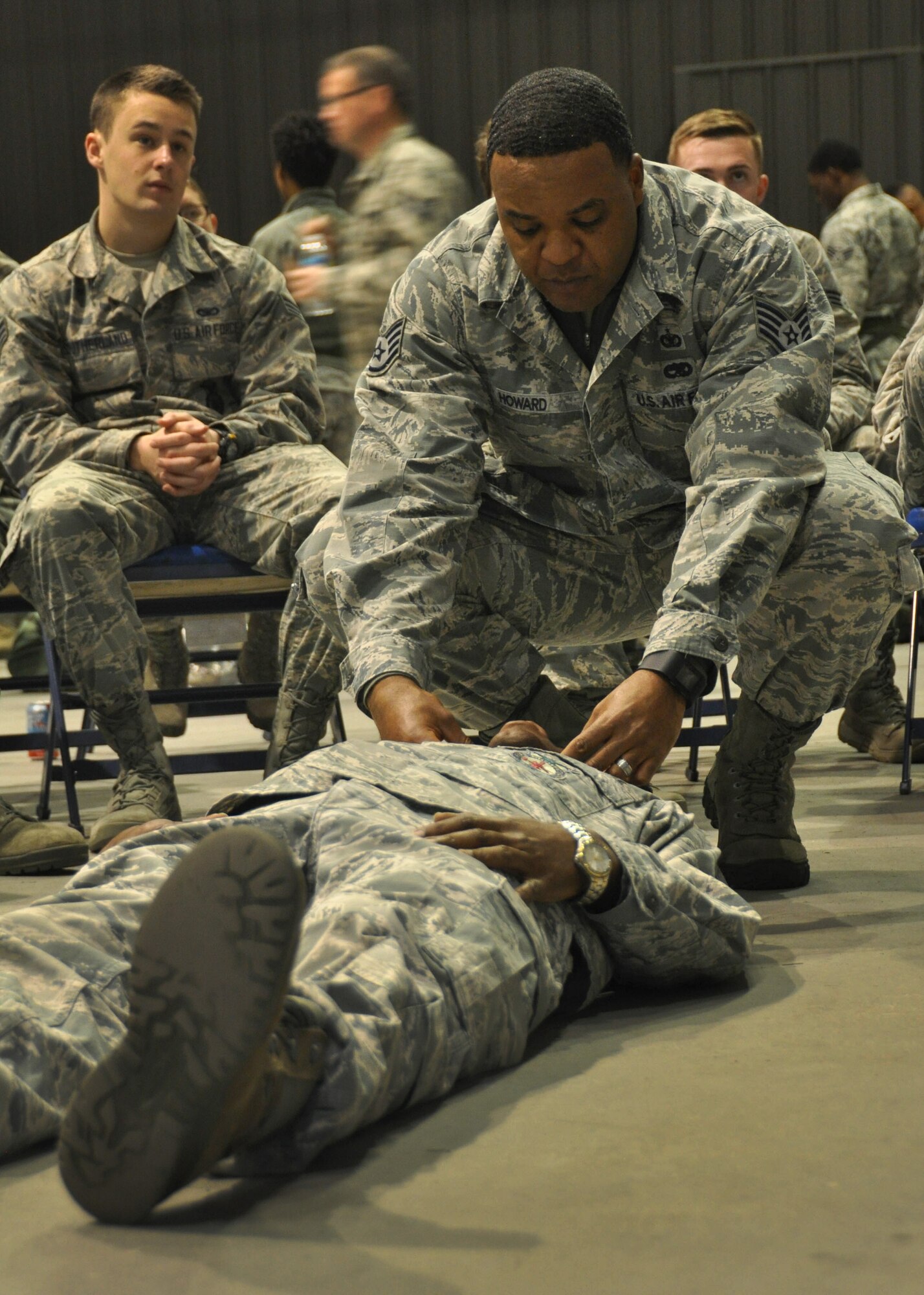A Self-Aid Buddy Care instructor demonstrates how to check an airway at Dobbins Air Reserve Base, Ga, March 5, 2016. The SABC course was part of a predeployment training that was held for the first time by Air Force Reserve Command. (U.S. Air Force Photo by Senior Airman Miles Wilson)