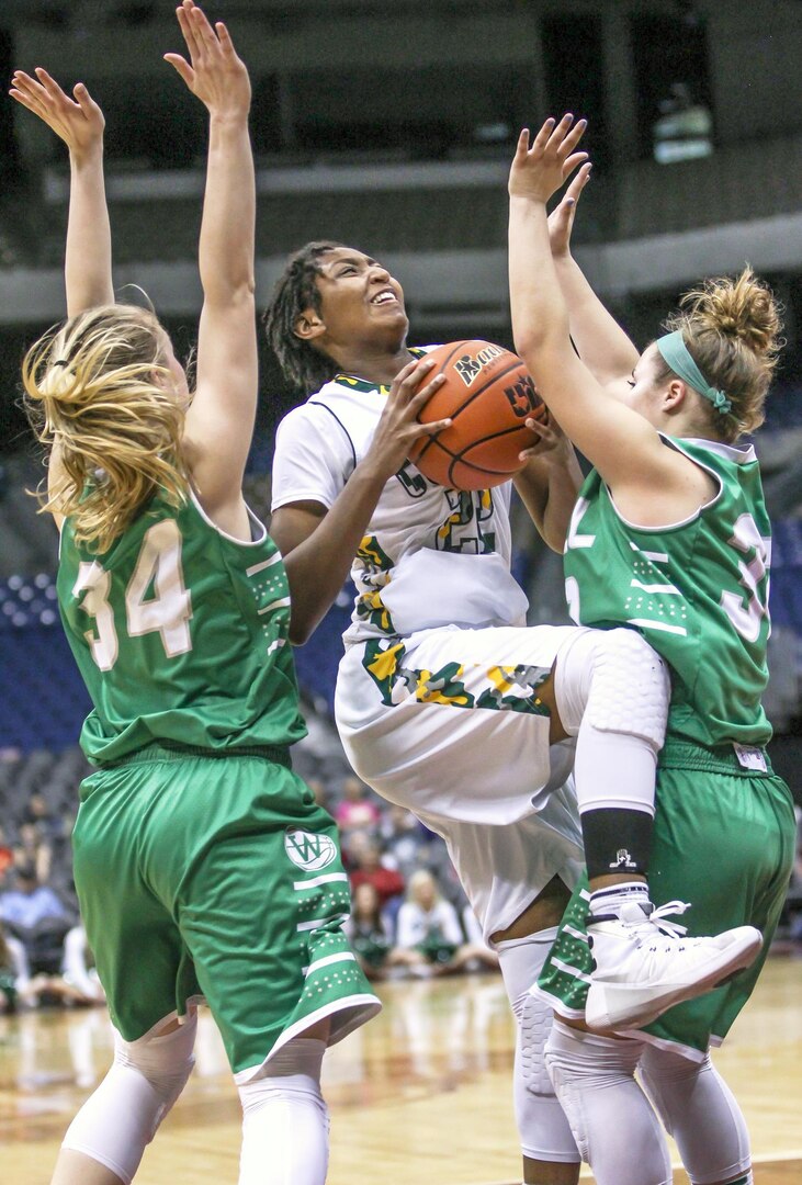 Cole High School senior Dalesia Booth (center) attempts to shoot around two
Wall High School defenders during the Region IV District 3 semifinal game
at the state championship at the Alamodome March 3. Wall won the game,
60-40.
