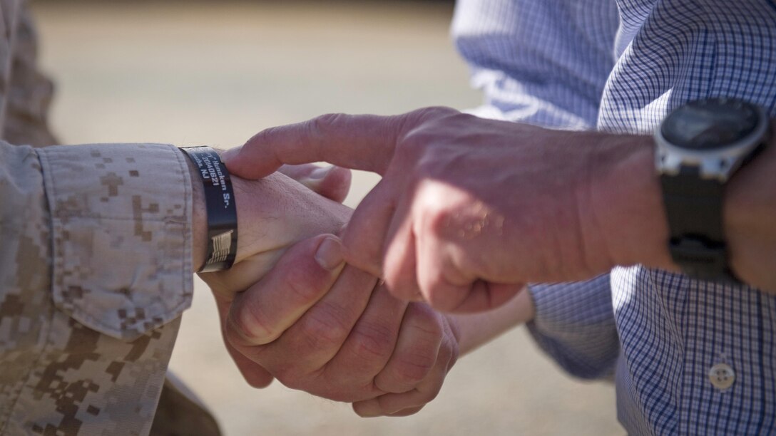 Secretary of Defense Ash Carter looks over a Killed in Action bracelet of a Marine at Marine Corps Base Quantico, Va., March 9, 2016. Secretary Carter was at the base to observe Marine Corps training and speak with Marines. (DoD photo by Senior Master Sgt. Adrian Cadiz)
