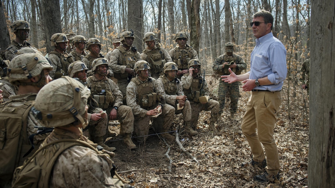 Marines at The Basic School participating in a a platoon in defense demonstration at Marine Corps Base Quantico, Va., take a break from training in order to speak with Secretary of Defense Ash Carter as he visits the base March 9, 2016. He visited the base to observe Marine Corps training and speak with Marines March 9, 2016.(DoD photo by Senior Master Sgt. Adrian Cadiz)