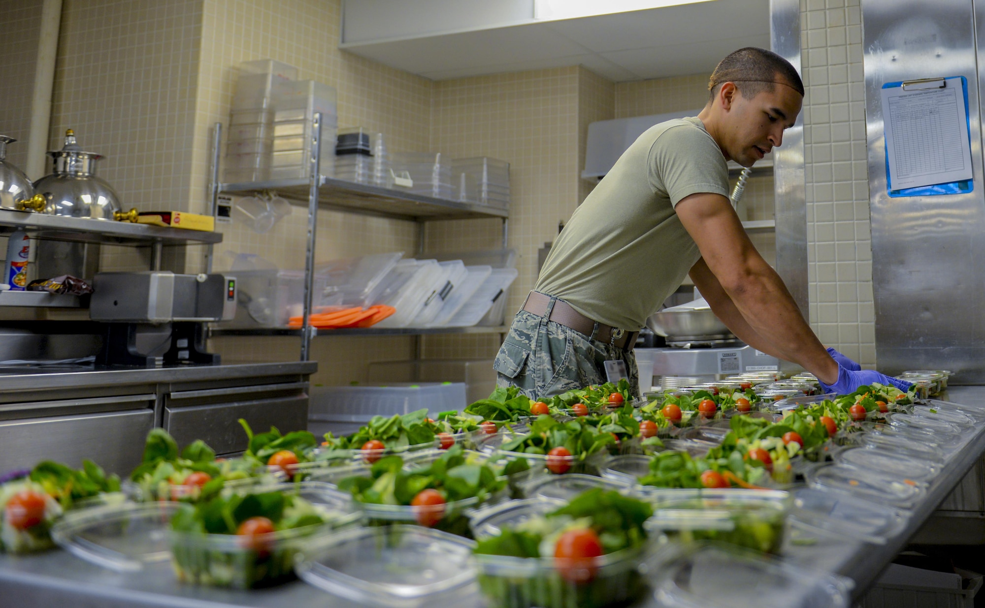 Airman 1st Class Chance Whitemore, 99th Medical Support Squadron, prepares individual salads at the Mike O’Callaghan Federal Medical Center dining facility at Nellis Air Force Base, Nev., March 4, 2016. March is National Nutrition Month® and is a nutrition education and information campaign created by the Academy of Nutrition and Dietetics. A new theme is created each year for the campaign and the theme for 2016 is “Savor the Flavor of Eating Right.” (U.S. Air Force photo by Airman 1st Class Nathan Byrnes)