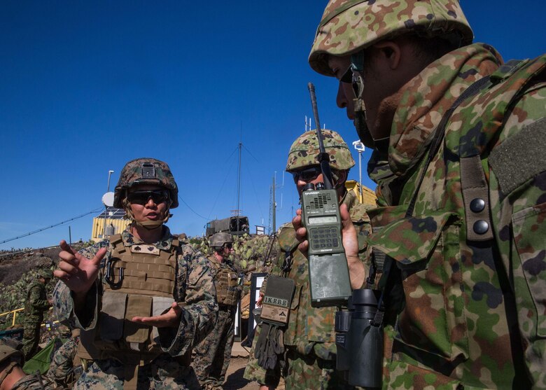 A U.S. Marine Corps interpreter attached to 1st Air Naval Gunfire Liaison Company translates radio messages for a soldier with Western Army Infantry Regiment, Japan Ground Self-Defense Force, during a supporting arms coordination center exercise, (SACCEX), on San Clemente Island, Feb. 22, 2016, as part of Exercise Iron Fist 2016. SACCEX  serves as a cooperative learning tool for the US-Japan partnership through the operation of a SACC, which has developed the USMC and JGSDF’s ability to intergrate naval gunfire, mortars and close-air support  as a combined force. (U.S. Marine Corps photo by Lance Cpl. Devan K. Gowans)