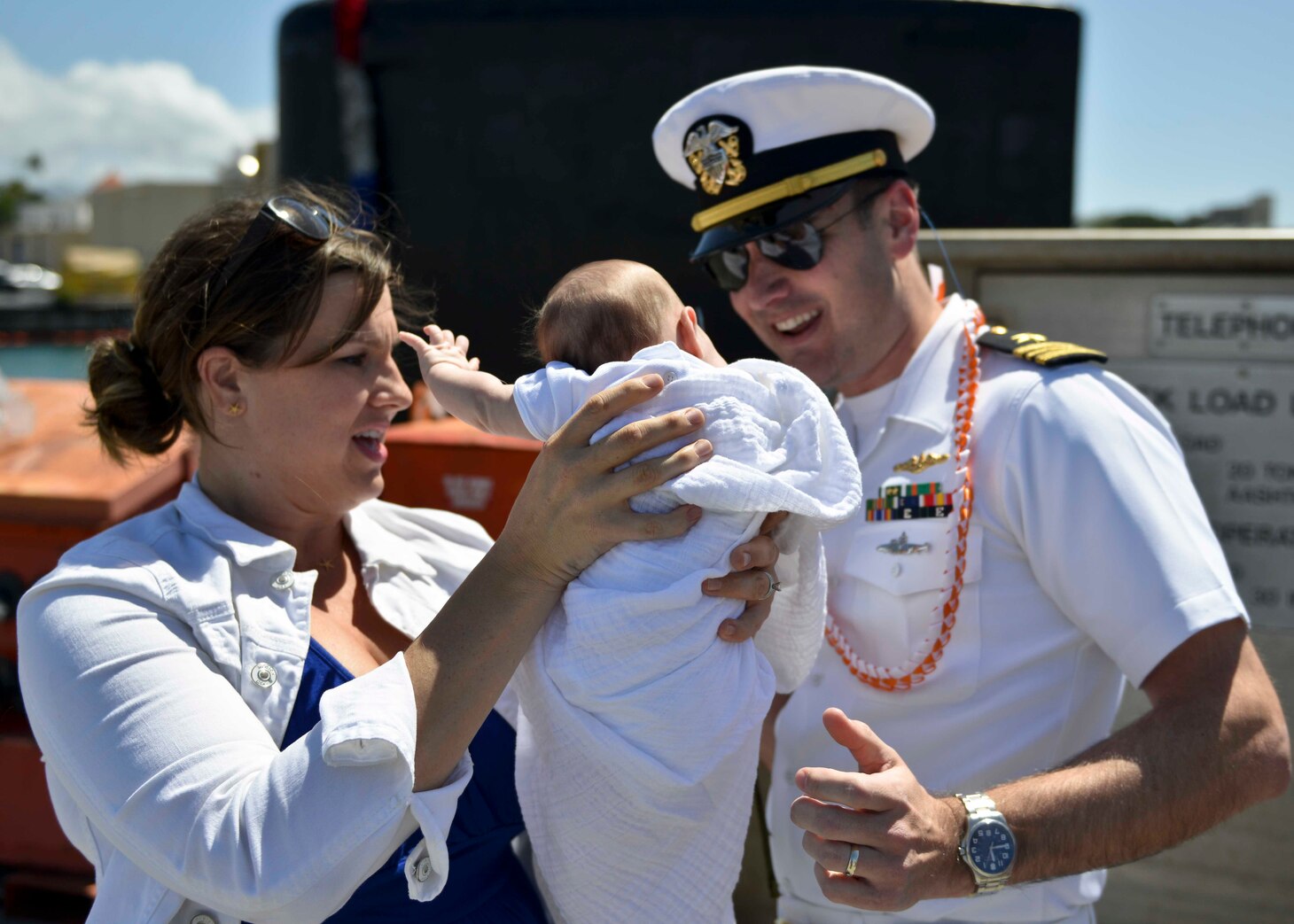 PEARL HARBOR (March 9, 2016) Lieutenant Commander Sean Gray of Nampa, Idaho, the executive officer of the Virginia-Class fast-attack submarine USS Texas (SSN 775), meets for the first time, his 7-week-old daughter, Vivian, presented to him by his wife, Jennifer, following the return of the submarine to Pearl Harbor, after completing a scheduled Western Pacific deployment. (U.S. Navy photo by Mass Communication Specialist 2nd Class Michael H. Lee/Released)