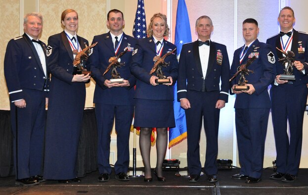 PETERSON AIR FORCE BASE, Colo. – From left, Col. Erich Novak, 302nd Airlift Wing vice-commander, Master Sgt. Cortney Shank, Tech. Sgt. Raymond Shaw, Staff Sgt. Dava MacDonald, Col. Jack H. Pittman, Jr., 302nd AW commander, Master Sgt. Eric Cross, and Lt. Col. Nathan Day pose with their new trophies March 5, 2016, after being recognized as top performers in their respective categories. Approximately 550 attendees were on hand to show their support for the Airmen at this year’s annual awards banquet. (U.S. Air Force photo/2nd Lt. Stephen Collier) 
