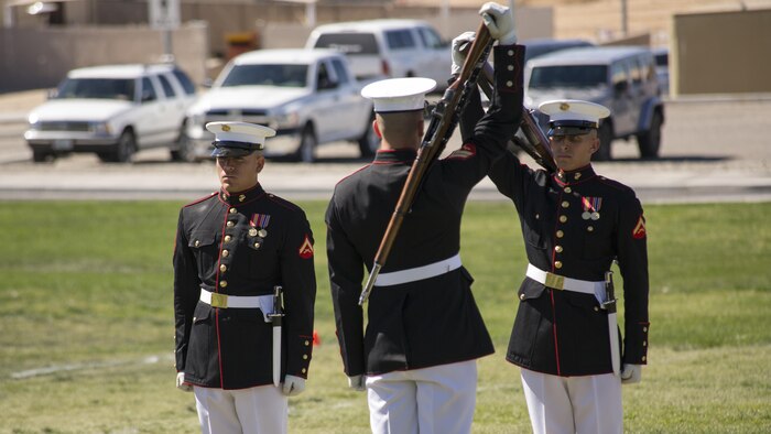 Marines with the Silent Drill Platoon of the Battle Color Detachment prepare to exchange rifles during a Battle Color Ceremony at Marine Corps Air Ground Combat Center Twentynine Palms, California March 9, 2016. The battle color ceremony features the U.S. Marine Drum & Bugle Corps, the Silent Drill Platoon, and the Marine Corps Color Guard.