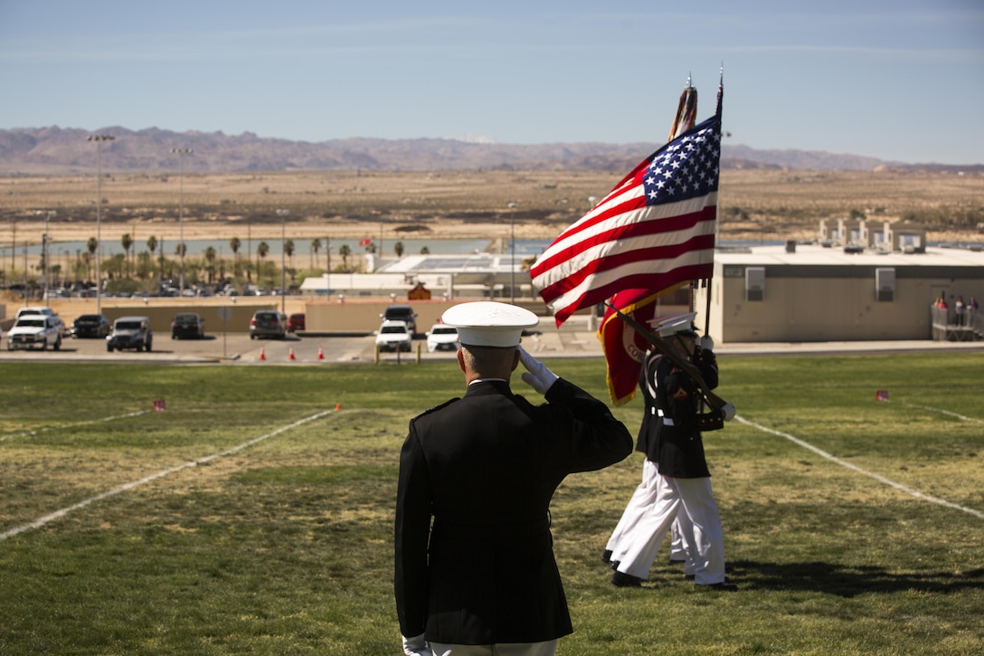 Maj. Gen. Lewis A. Craparotta, commanding general, Combat Center, salutes the national and Marine Corps colors carried by the Official Marine Corps Color Guard during a Battle Colors Ceremony at Marine Corps Air Ground Combat Center Twentynine Palms, California March 9, 2016. The battle color ceremony features the U.S. Marine Drum & Bugle Corps, the Silent Drill Platoon, and the Marine Corps Color Guard.