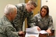 445th Airlift Wing legal office members, Lt. Col, Gregory Baxley, Tech. Sgt. Matthew J. McDonald III and Master Sgt. Rebeccah Stammen, review legal documents during the Feb. 7, 2016 unit training assembly. The wing's legal office helps Airmen with documents like wills, notaries, powers of attorney, and advance medical directives.