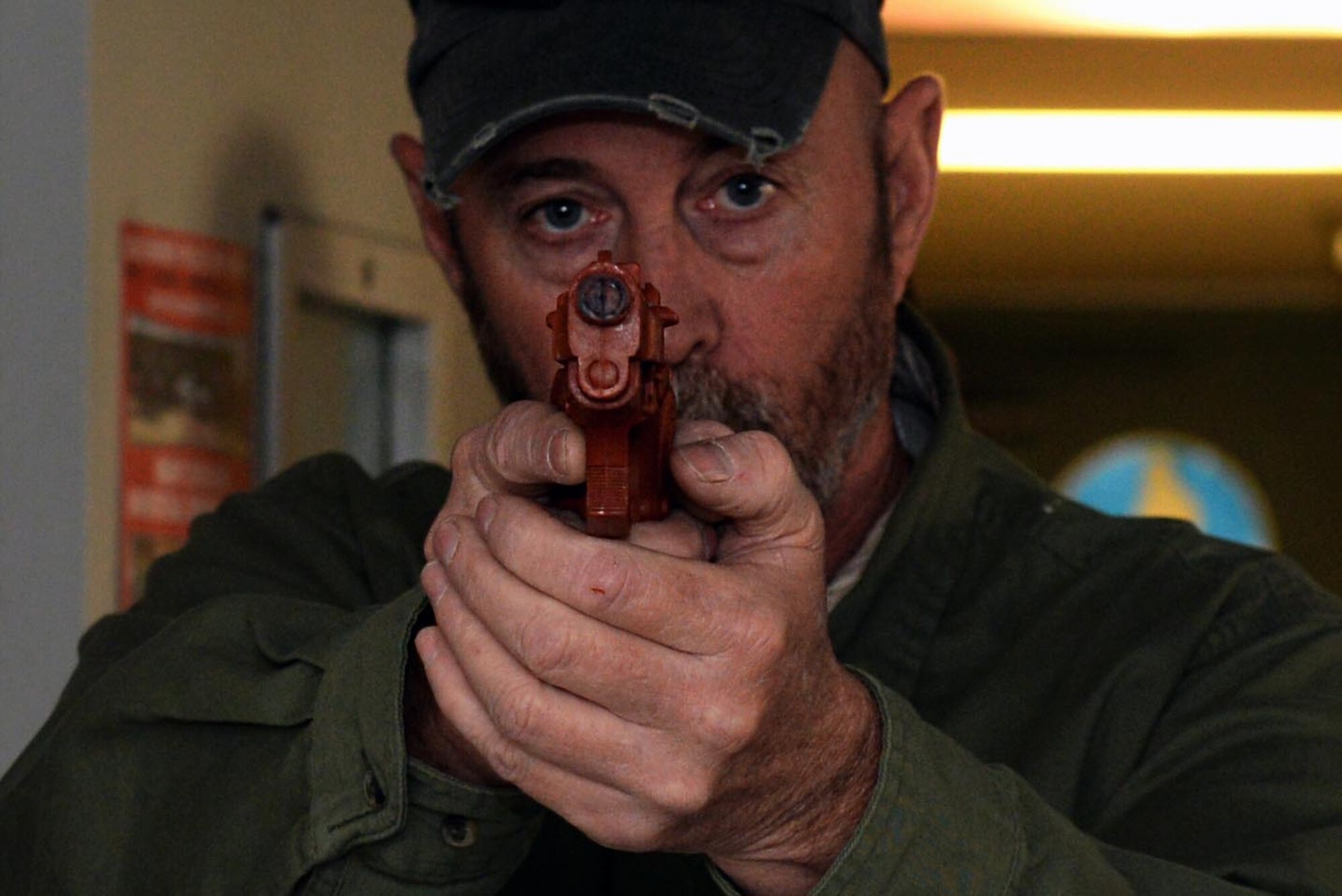 Andy Anderson, 4th Security Forces Squadron lead security forces law enforcement special weapons and tactics officer, instructs Airmen how to ensure hallways are safe with a weapon during an active shooter training exercise, March 3, 2016 at Seymour Johnson Air Force Base, North Carolina. With 20 Airmen per class, the training course provides basic information on how to defend yourself or escape from a building during an active shooter incident. (U.S. Air Force photo/Airman 1st Class Ashley Williamson)