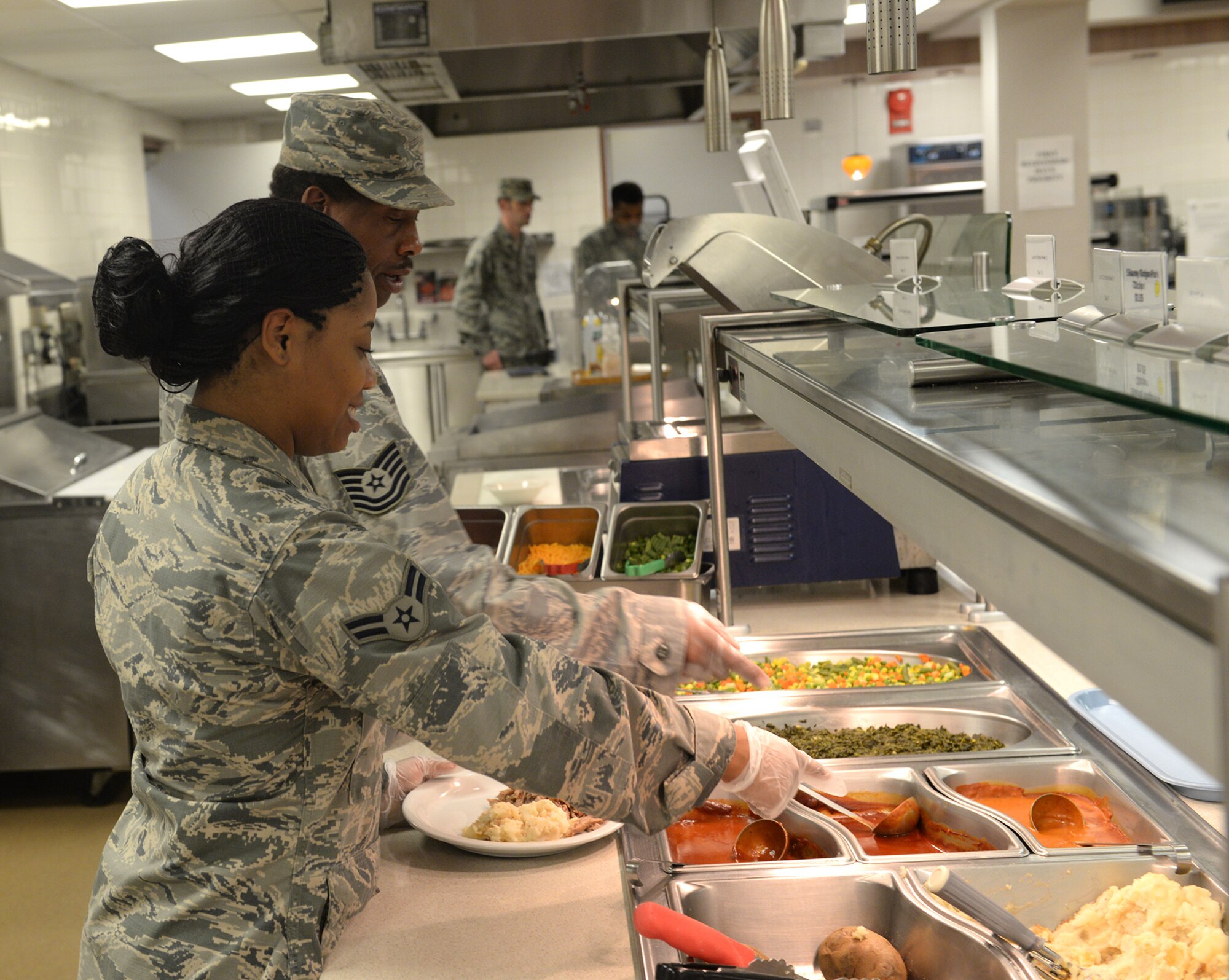 Red River Dining Facility personnel from the 2nd Force Support Squadron served food amid flash flood conditions at Barksdale Air Force Base, La., March 9, 2016. (U.S. Air Force photo/Airman 1st Class Curt Beach)