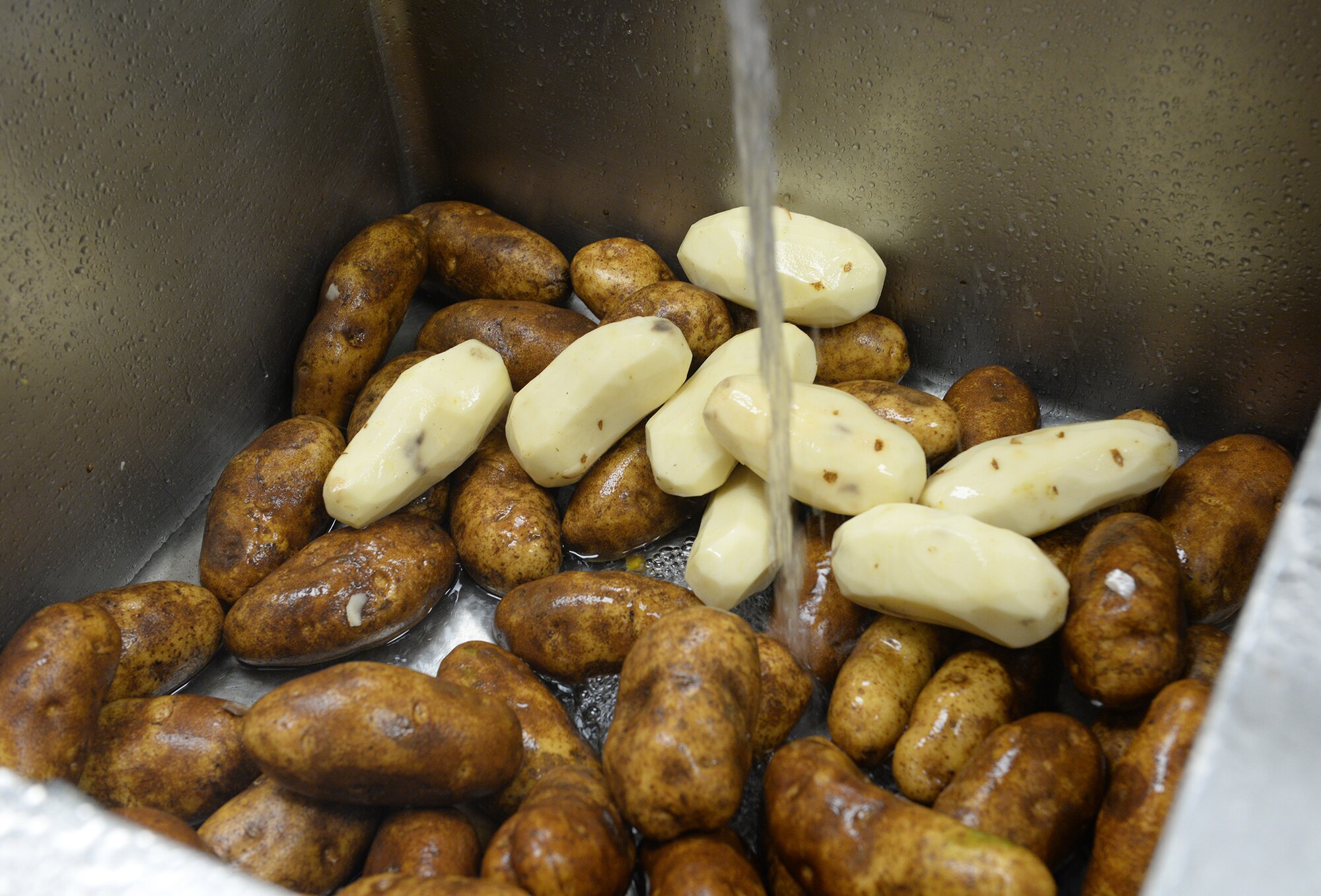 Potatoes are skinned and washed at the Red River Dining Facility at Barksdale Air Force Base, La., March 9, 2016. (U.S. Air Force photo/Airman 1st Class Curt Beach)
