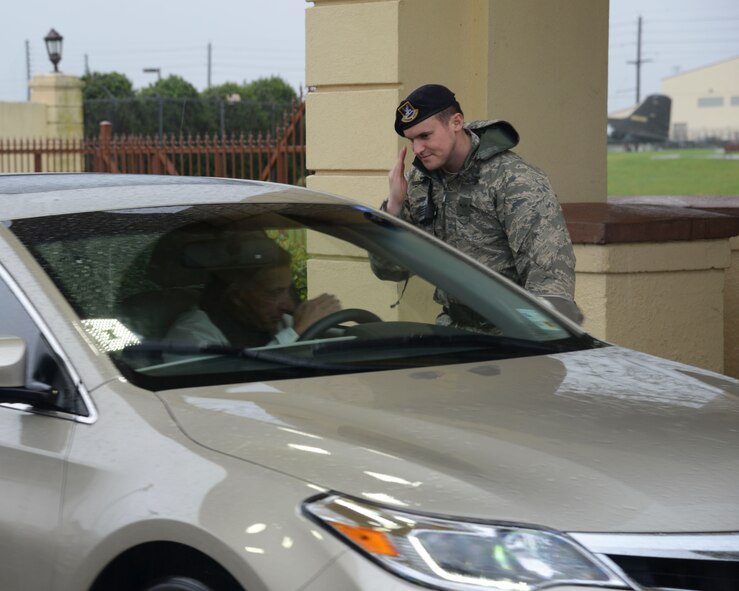 A 2nd Security Forces Squadron defender welcomes a visitor to Barksdale Air Force Base, La., March 10, 2016. (U.S. Air Force photo/ Senior Airman Jannelle Dickey)