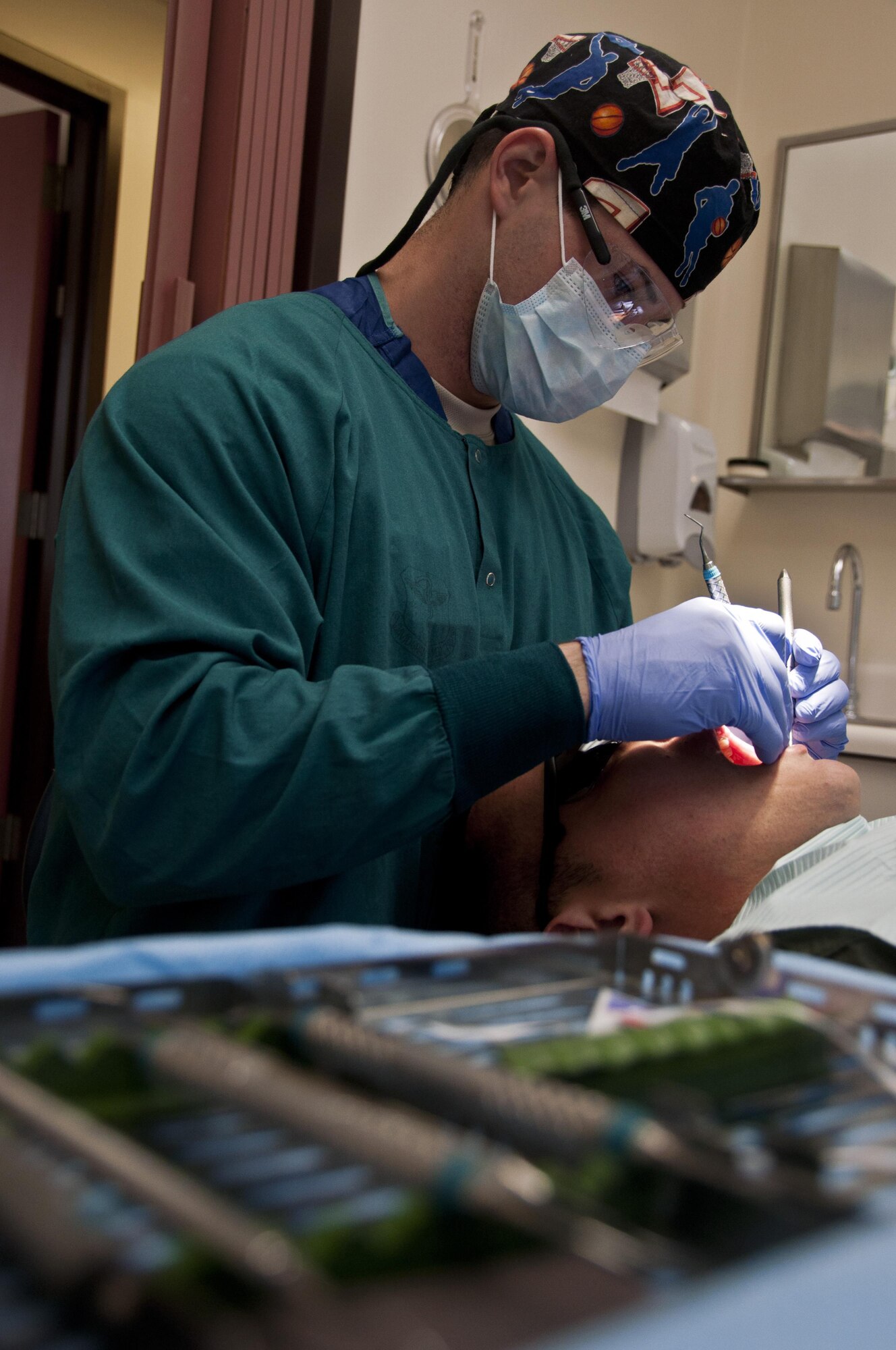 Staff Sgt. Anthony Molosz, 60th Medical Group Dental Squadron dental assistant, provides routine oral care for a patient at David Grant USAF Medical Center April 30. (U.S. Air Force photo/Senior Airman Madelyn Brown)
