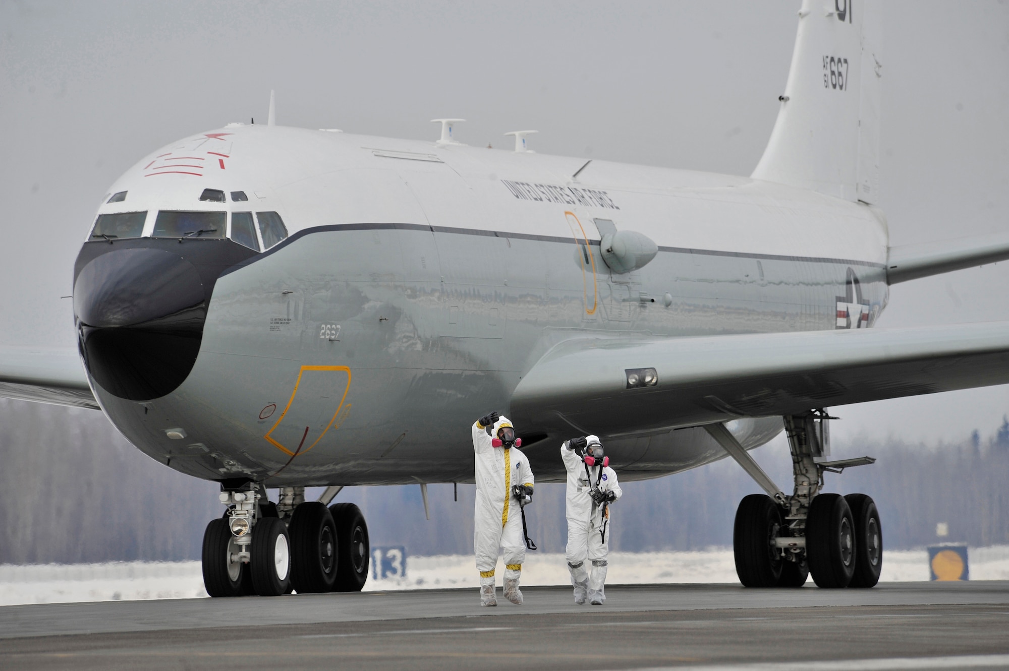 EIELSON AIR FORCE BASE, Alaska -- Personnel from the 55th Aerospace Medicine Squadron and 55th Aircraft Maintenance Squadron report a "thumbs down," which indicates the WC-135 Constant Phoenix aircraft is above acceptable levels of contamination and needs be parked in an isolated location to be decontaminated. This initial radiation survey was done every time the WC-135 landed after collecting air samples in international airspace over the Pacific as part of Operation Tomodachi. (Air Force photo by Staff Sgt. Christopher Boitz)