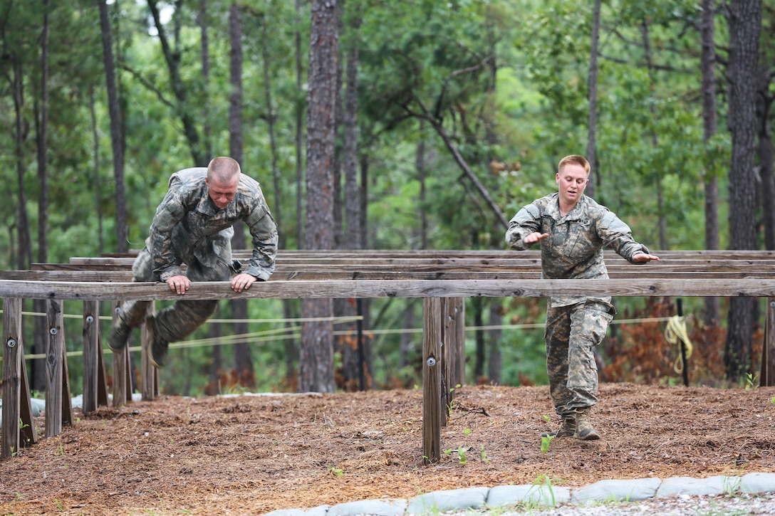 Army Maj. Lisa Jaster, right, takes on the Darby Queen obstacle course during the Ranger Course at Fort Benning Ga., June 28, 2015. Jaster was the third woman to earn the Ranger Tab. Army photo by Staff Sgt. Scott Brooks