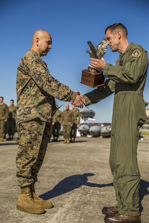Gunnery Sgt. Carlos Aguilar, left, is presented an award by Lt. Col. Harry F. Thomas, in recognition of his leadership during a ceremony at Marine Fighter Attack Squadron 312 aboard Marine Corps Air Station Beaufort March 2.  During the ceremony, Aguilar was presented with the Navy & Marine Association Leadership Award, a peer-selected recognition. The association sponsors more than 400 awards annually for commanders to recognize officers and enlisted personnel who have been selected by their peers as outstanding leaders in their respective communities. Aguilar is a maintenance controller with VMFA-312. Thomas is the commanding officer of VMFA-312.