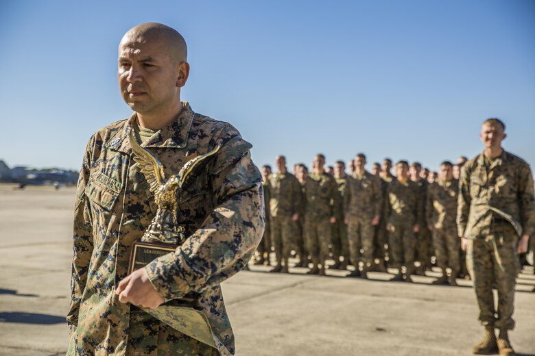 Gunnery Sgt. Carlos Aguilar, left, stands in front of formation after receiving an award in recognition of his leadership during a ceremony at Marine Fighter Attack Squadron 312 aboard Marine Corps Air Station Beaufort March 2.  During the ceremony, Aguilar was presented with the Navy & Marine Association Leadership Award, a peer-selected recognition. The association sponsors more than 400 awards annually for commanders to recognize officers and enlisted personnel who have been selected by their peers as outstanding leaders in their respective communities. Aguilar is a maintenance controller with VMFA-312. 