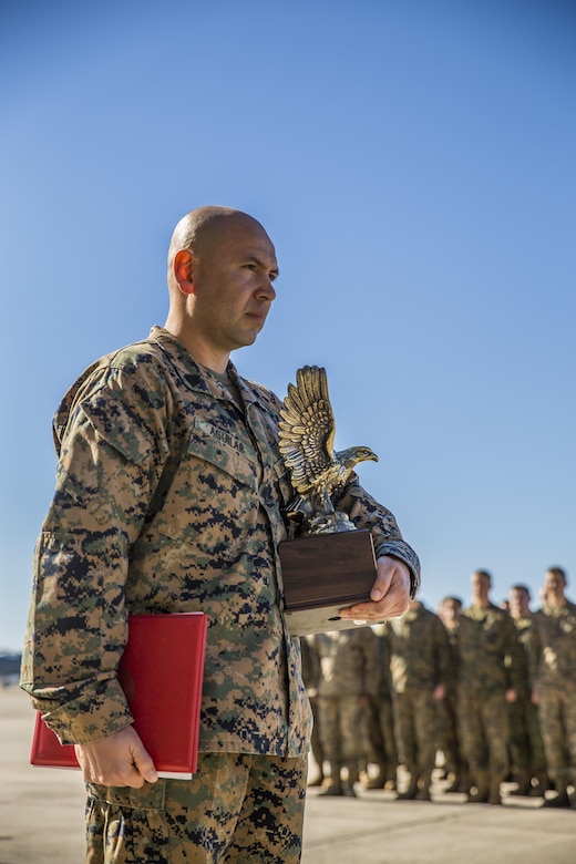Gunnery Sgt. Carlos Aguilar stands in front of formation after receiving an award in recognition of his leadership during a ceremony at Marine Fighter Attack Squadron 312 aboard Marine Corps Air Station Beaufort March 2.  During the ceremony, Aguilar was presented with the Navy & Marine Association Leadership Award, a peer-selected recognition. The association sponsors more than 400 awards annually for commanders to recognize officers and enlisted personnel who have been selected by their peers as outstanding leaders in their respective communities. Aguilar is a maintenance controller with VMFA-312.