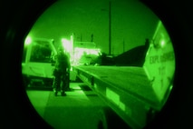 U.S. Air Force Senior Airman Anthony McGee, 51st Munitions Squadron storage crew chief, performs spotter duties to ensure munitions are loaded safely onto a trailer during exercise Beverly Midnight 16-01, Osan Air Base, Korea, March 11, 2016. Once an exercise begins, the munitions storage Airmen go into 24-hour operations and man five crews at all times to make sure bombs are ready to be delivered to armament Airmen who then put the bombs together and load them on aircraft. (U.S. Air Force photo by Staff Sgt. Rachelle Coleman/Released)