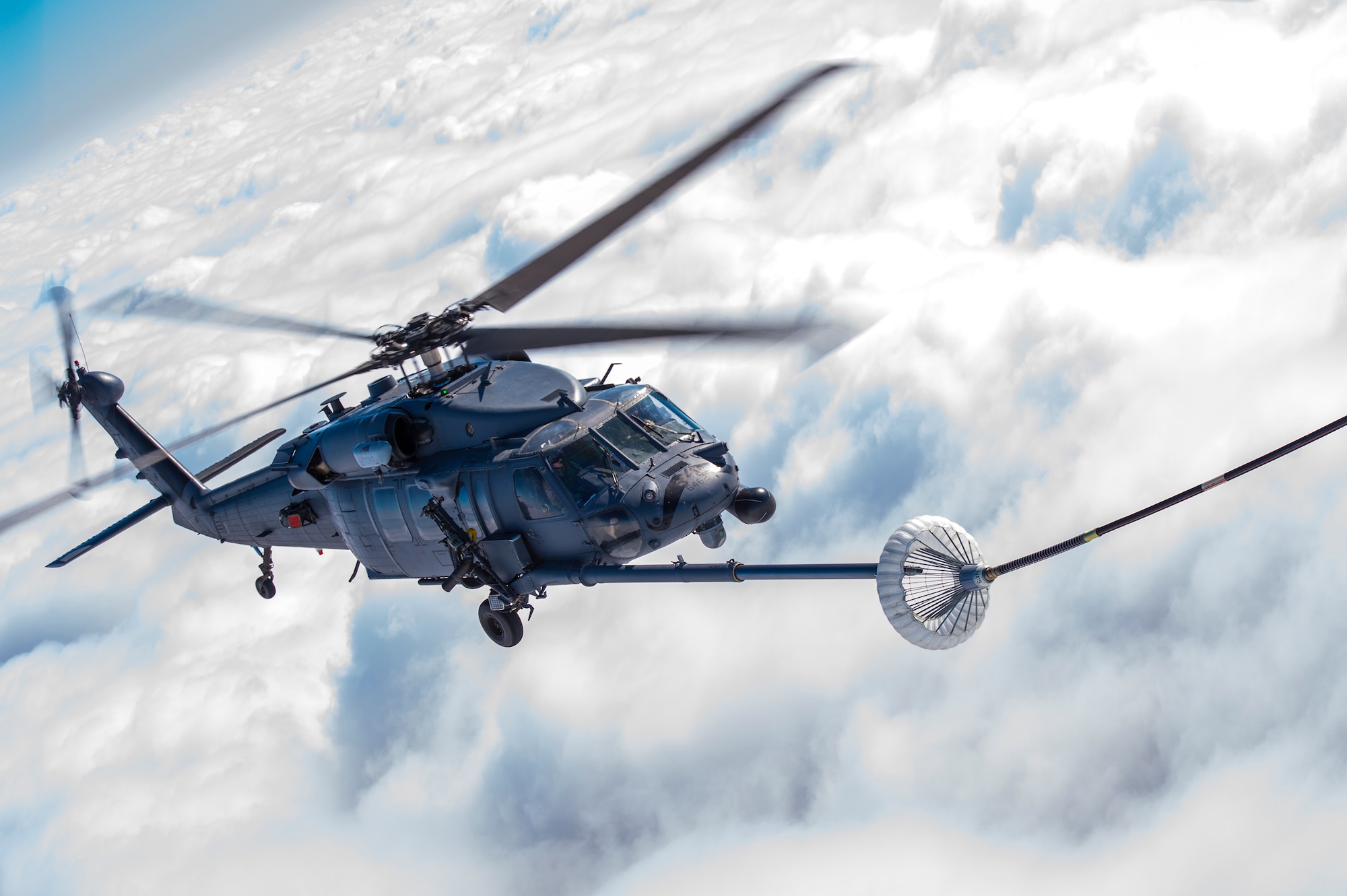 An HH-60G Pave Hawk participates in an in-flight aerial refueling as part of the East Coast Airpower Demonstration, at Moody Air Force Base, Ga., March 4, 2015. During the visit, congressional delegates viewed multiple aircraft perform a simulated combat search and rescue and close air support operation. (U.S. Air Force photo by Senior Airman Ryan Callaghan/Released)