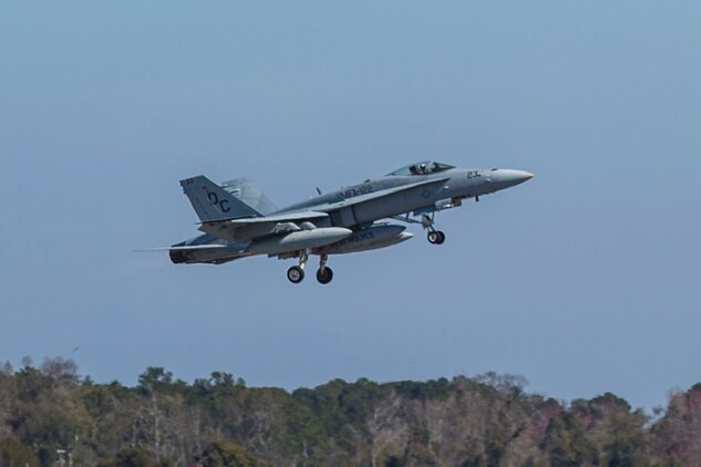 An F/A-18C Hornet takes-off on the flight line aboard Marine Corps Air Station Beaufort March 7. Marine Fighter Attack Squadron 122 departed for the Western Pa¬cific March 7 as part of the Unit Deployment Program. The squadron will sup¬port 6 multinational ex¬ercises, which will not only increase the readi¬ness of the Marines but safeguard international goodwill and ensure we can work with our allies effectively. The Hornet is with VMFA-122.