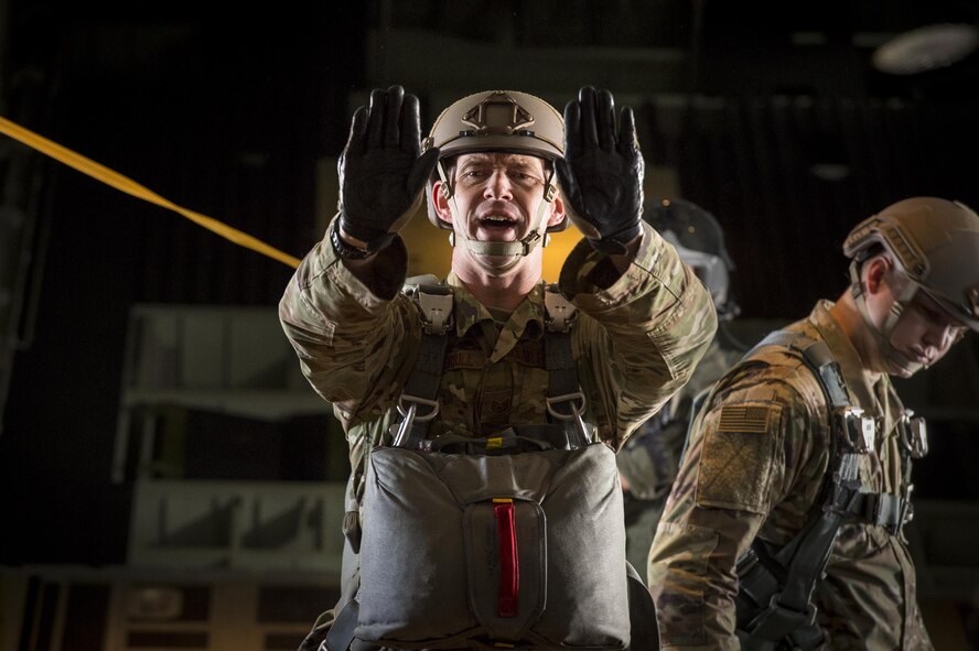 U.S. Air Force Tech. Sgt. Willie Sherill, 820th Base Defense Group jumpmaster, signals to jumpers as part of the East Coast Airpower Demonstration, at Moody Air Force Base, Ga., March 4, 2015. The East Coast Air Power Demonstration allowed the delegation to spend the day with Airmen and get a firsthand look at the mission, capabilities and platforms that the Air Force provides to combatant commanders in support of global operations. (U.S. Air Force photo by Senior Airman Ryan Callaghan/Released)