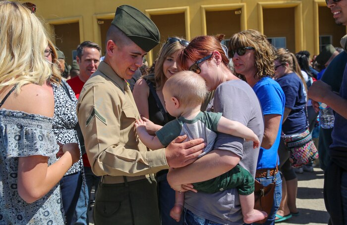 A Marine from India Company, 3rd Recruit Training Battalion, greets his loved ones after being released for liberty at Marine Corps Recruit Depot San Diego, March 10. This is the first time Marines have seen their families and friends since arriving at the depot 13 weeks ago. Annually, more than 17,000 males recruited from the Western Recruiting Region are trained at MCRD San Diego. India Company is scheduled to graduate March 11.