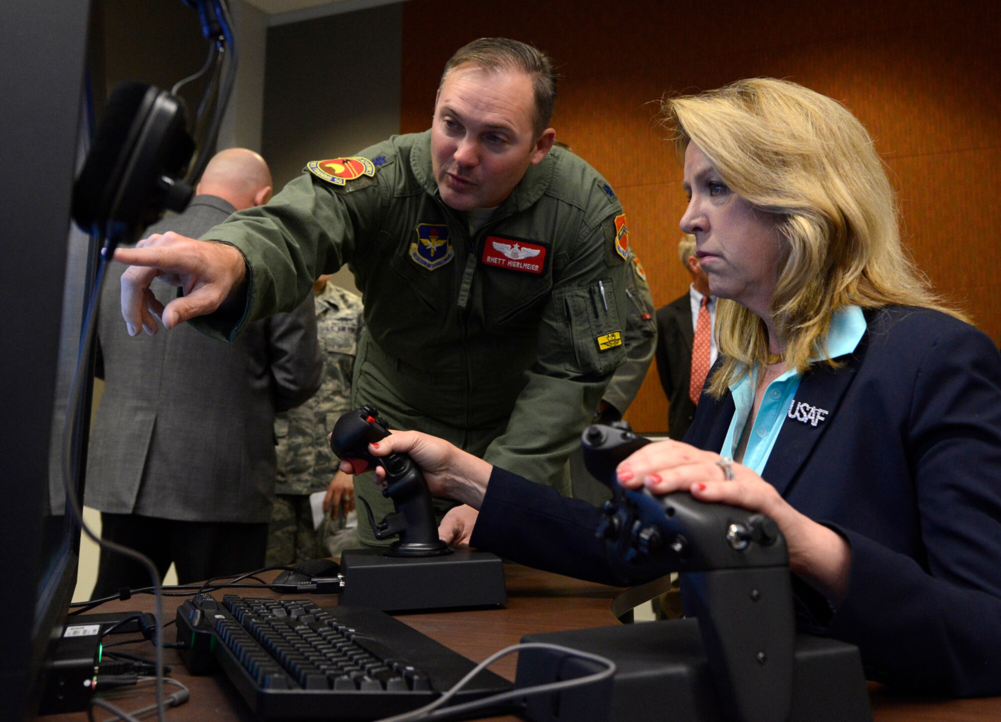 Secretary of the Air Force Deborah Lee James, receives instruction from Lt. Col. Rhett Hierlmeier, 56th Training Squadron director of operations on a flight simulator, March 10, 2016, at Luke Air Force Base, Ariz. James toured the Academic Training Center and received briefings on the progress of F-35 Lightning II operations, pilot training, and simulators. (U.S. Air Force photo by Senior Airman Devante Williams)