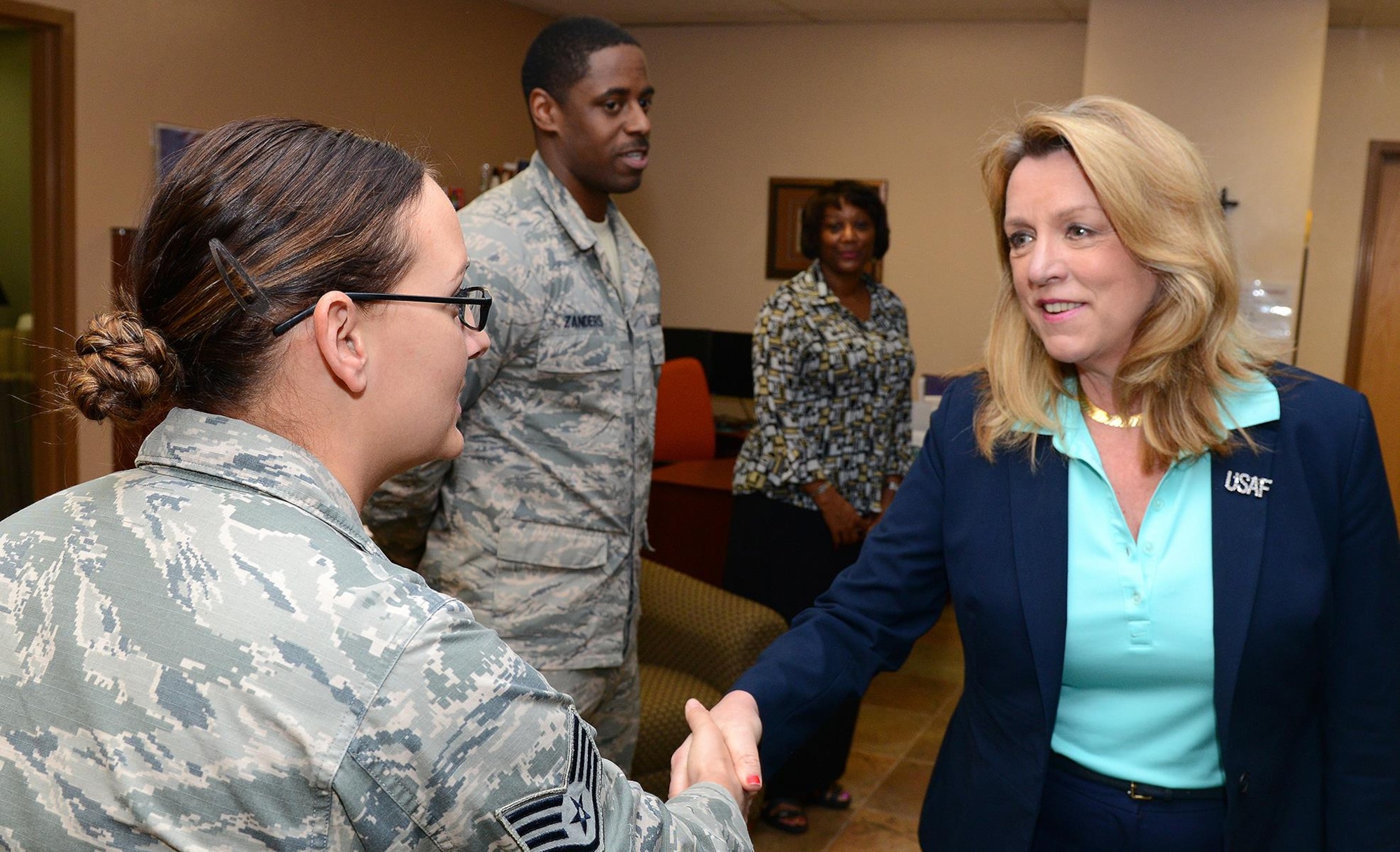 Secretary of the Air Force Deborah Lee James, poses with members of the 56th Fighter Wing sexual assault prevention and response team, March 10, 2016, at Luke Air Force Base, Ariz. James visited Luke to receive updates on the progress of the F-35 Lightning II program. James toured Luke Air Force Base receiving a briefing about the SAPR office and services offered through the agency. (U.S. Air Force photo by Senior Airman James Hensley)