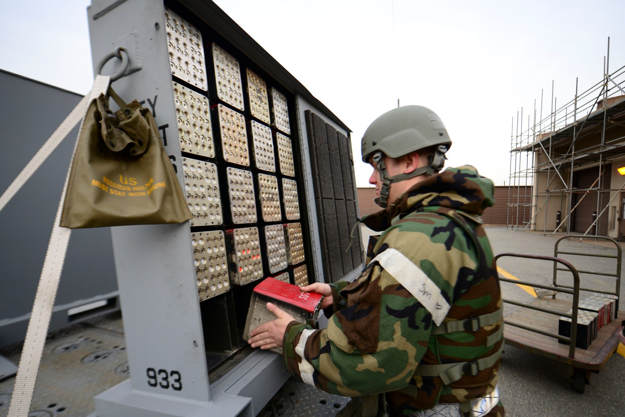 Staff Sgt. Jeffery Brown, 51st Munitions Squadron conventional maintenance crew chief, loads chaff and flares onto a weapons trailer during combat readiness exercise Beverly Midnight 16-01, March 9, 2016, at Osan Air Base, Republic of Korea. Team Osan members donned Mission Oriented Protective Posture gear during BM 16-01 to test their ability to survive and operate in a wartime environment. (U.S. Air Force photo by Staff Sgt. Jonathan Steffen/Released)