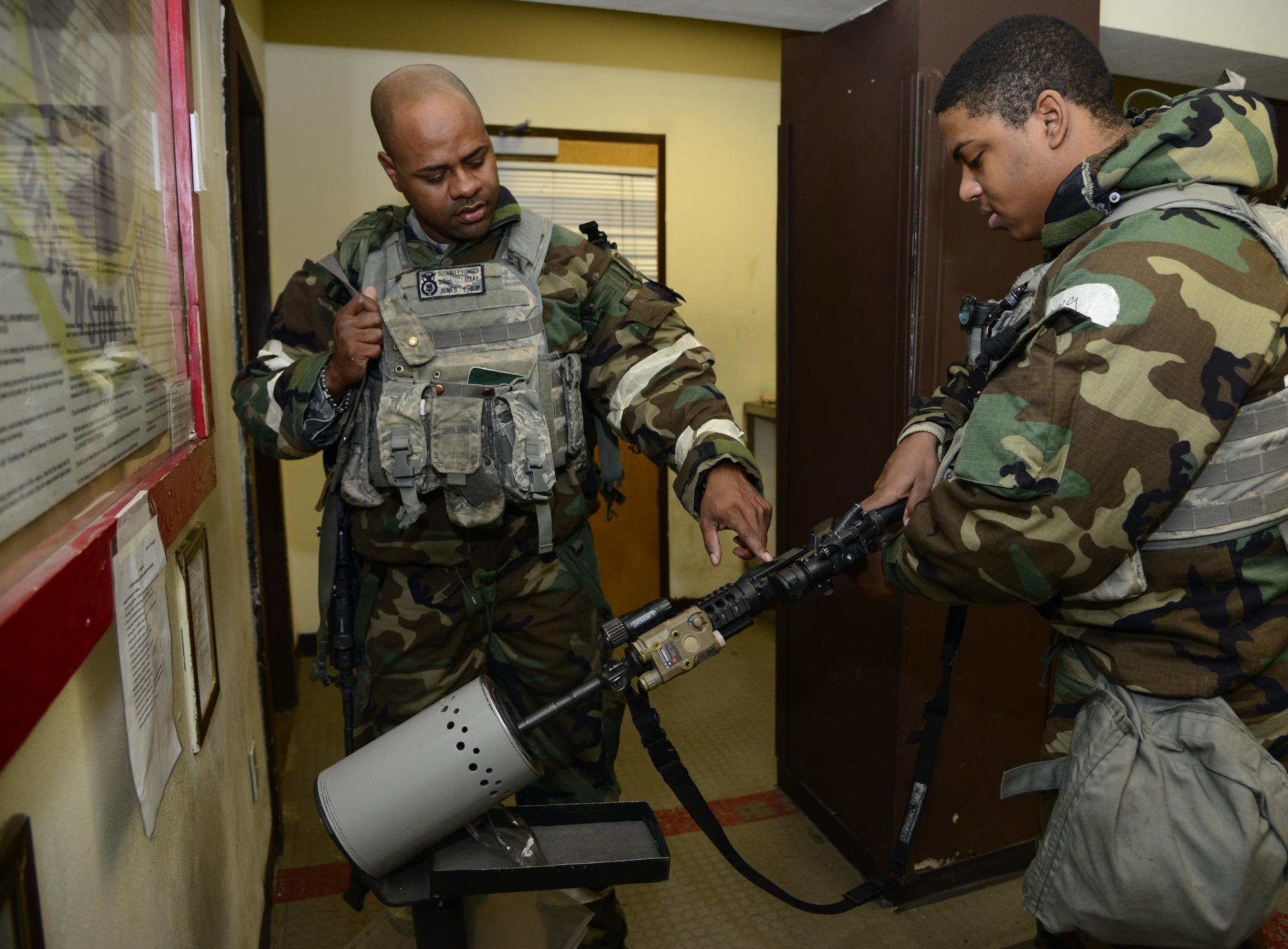 Staff Sgt. Philip Jones, 51st Security Forces Squadron defender, assists Airman 1st Class Aaron Hill, 51st Fighter Wing entry controller, with clearing his M-4 rifle during Exercise Beverly Midnight 16-01 on Osan Air Base, Republic of Korea, March 10, 2016. A clearing barrel official ensures the weapon is safe before turning it into the armory. (U.S. Air Force photo by Senior Airman Kristin High/Released)