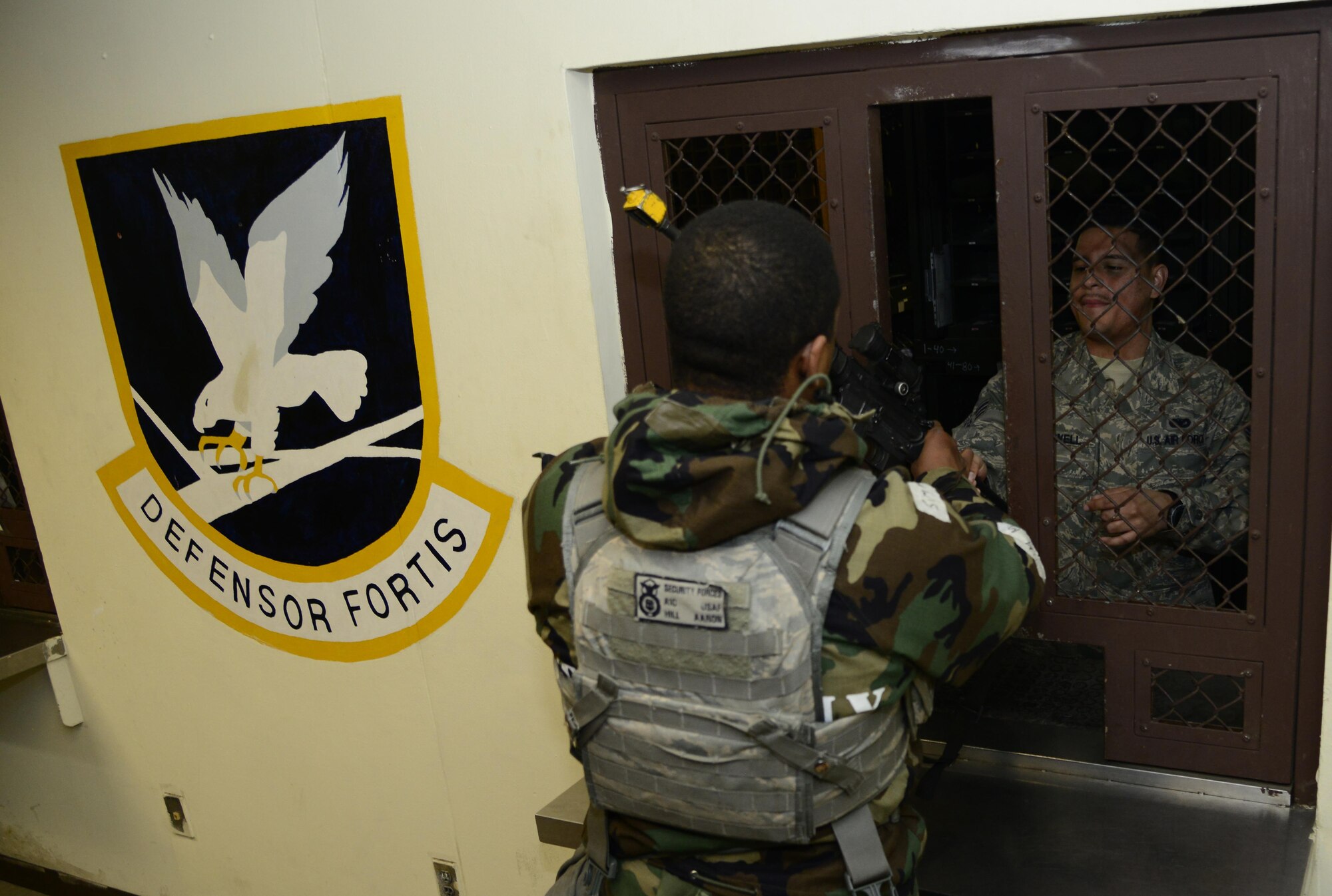 Airman 1st Class Aaron Hill, 51st Fighter Wing entry controller, turns in an M-4 rifle to Senior Airman Sidney Maxwell, 51st Security Forces Squadron armorer during Exercise Beverly Midnight 16-01 on Osan Air Base, Republic of Korea, March 10, 2016. During the exercise, defenders and some augmentees in the exercise were issued weapons with blank firing adapters, which allow them to train in a more realistic environment without anyone being harmed. (U.S. Air Force photo by Senior Airman Kristin High/Released)