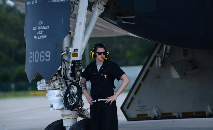 U.S. Air Force Staff Sgt. Seth Calkins, a crew chief from the 393rd Aircraft Maintenance Unit, waits for a B-2 Spirit to taxi across the runway while deployed to an undisclosed location in the U.S. Pacific Command area of operations March 10 2016. U.S. Strategic Command routinely demonstrates its capability to command, control and conduct global bomber missions. (U.S. Air Force photo by Senior Airman Joel Pfiester/Released) 