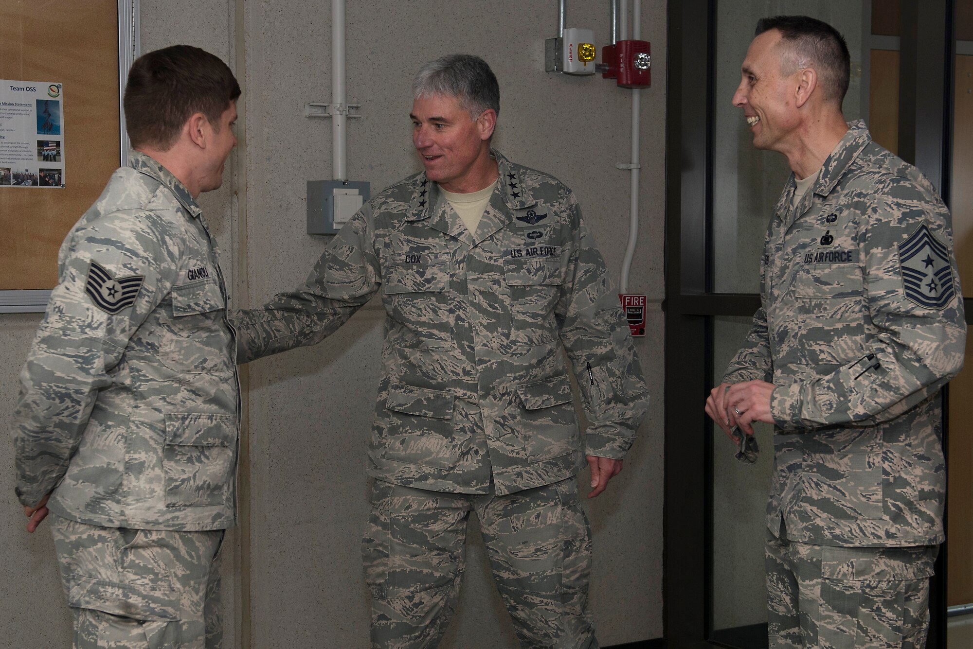 Lt. Gen. Sam Cox, 18th Air Force commander, and Chief Master Sgt. Todd Petzel, 18th AF command chief, recognizes a 375th Operations Group's star performer, Tech. Sgt. Nick Gianoli, Mar. 4, 2016, at Scott Air Force Base, Illinois. This was part of Cox’s tour of the base control tower where he was briefed on the upcoming plans for the airfield such drop zones and how they felt the airfield would handle to increased mission load. (U.S. Air Force photo/Senior Airman Kiana Brothers)