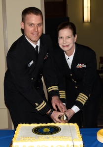 Lt. Matthew Middendorf, a physician at Naval Health Clinic Charleston, and Capt. Rosemary Malone, a psychiatrist and NHCC executive officer, cut the cake during NHCC's celebration of the Navy Medical Corps' 145th birthday March 4, 2016 at NHCC, Joint Base Charleston - Weapons Station. The Navy Medical Corps was founded on March 3, 1871 and consists of physicians in a variety of specialties. (U.S. Navy photo/ Kris Patterson)
