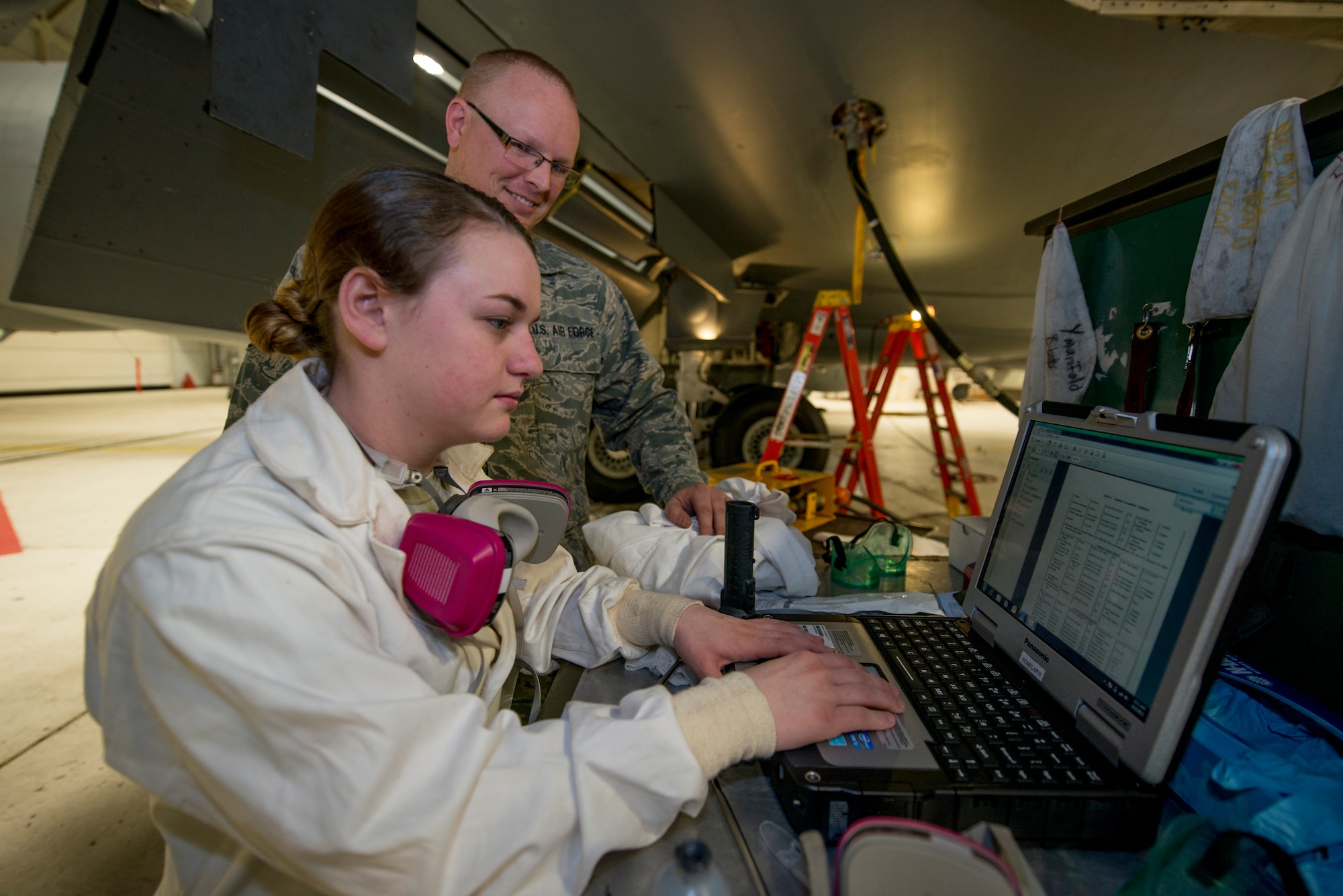 Staff Sgt. Jonathan Phillips, 141st Maintenance Squadron fuel cell technician, looks on as Airman 1st Class Sarah Deberardinis, 141st MXS fuel cell technician, checks technical data prior to starting a repair on a KC-135 Stratotanker fuel cell at Fairchild Air Force Base, Wash. Without fuel systems specialists, the KC-135 would never get off the ground and could not deliver fuel to other aircraft, making fuels systems specialists the backbone of how the Air Force fuels the fight.  (U.S. Air Force photo/Tech. Sgt. Michael Lee Brown)