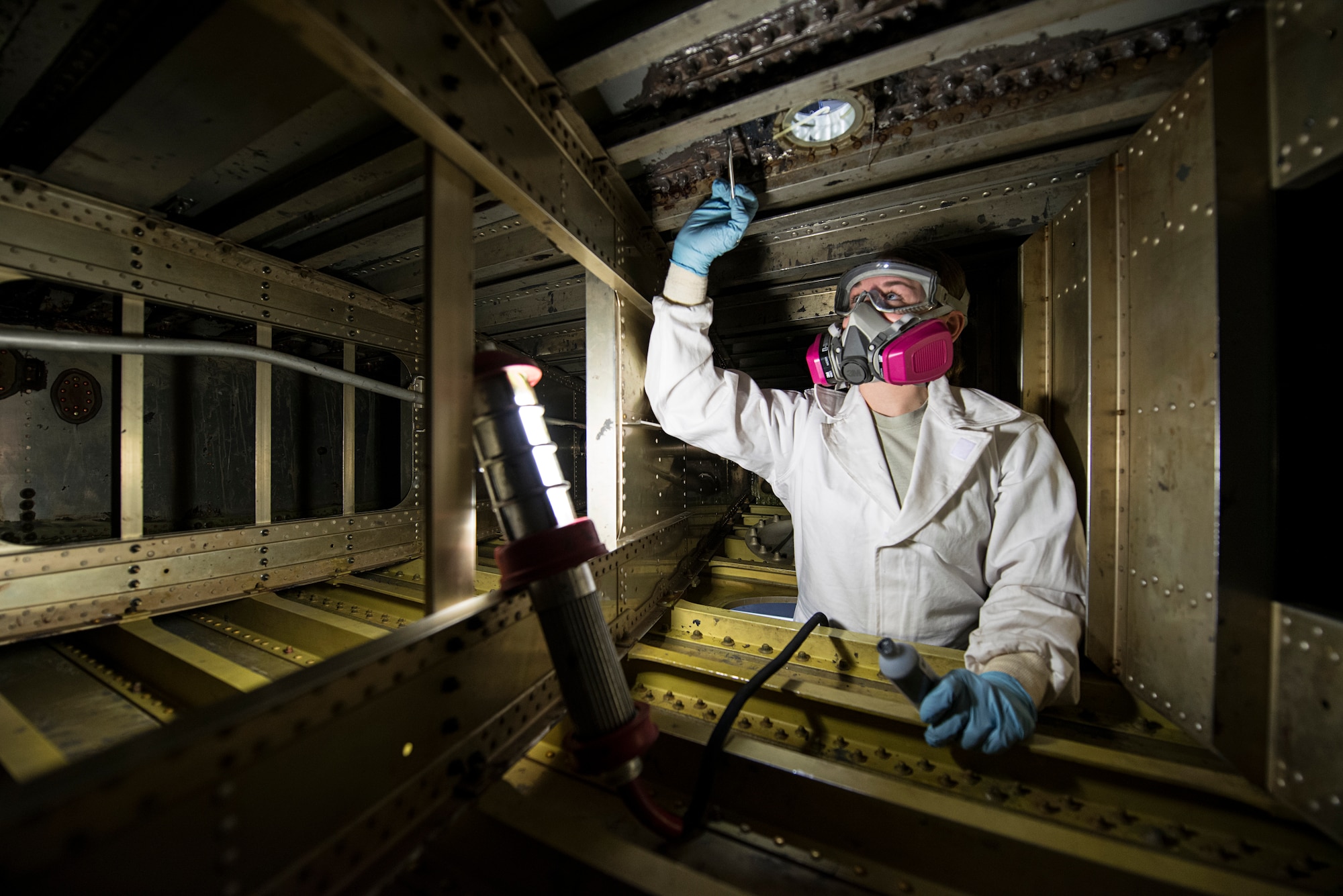 Airman 1st Class Sarah M. Deberardinis, 141st Maintenance Squadron fuel cell technician, makes a repair to the inside of a KC-135 Stratotanker fuel cell at Fairchild Air Force Base, Wash. Tankers offload fuel to aircraft that deliver close air support, airborne intelligence, search and rescue. (U.S. Air Force photo/Tech. Sgt. Michael Lee Brown)
