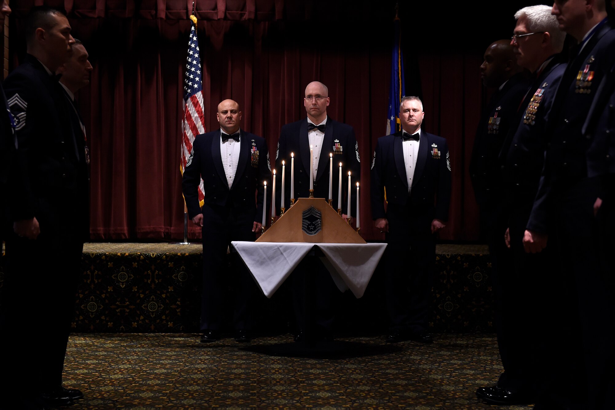 Chief master sergeants and chief master sergeant selects conclude a candle lighting ceremony during the chief master sergeant induction ceremony March 4, 2016, Joint Base Lewis-McChord, Wash. One Airman from each rank of the enlisted ranks lights a candle symbolizing the path a chief master sgt. takes through the ranks.  (U.S. Air Force photo/Tech. Sgt. Tim Chacon)