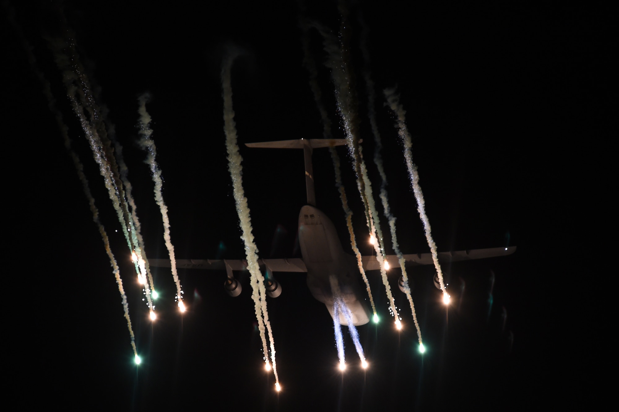 A McChord C-17 Globemaster III ejects flares over the test range at Eglin Air Force Base, Fla., March 4, 2016. The C-17 Aircrew from Joint Base Lewis-McChord, Wash., and the C-5 aircrew from Travis AFB, Calif., flew to Eglin to test the aircraft defense systems as part of Air Mobility Command’s flare effectiveness testing with Georgia Tech Research Institute. The automated defense mechanism on the aircraft is only 26 years old. (U.S. Air Force photo/Staff Sgt. Naomi Shipley)