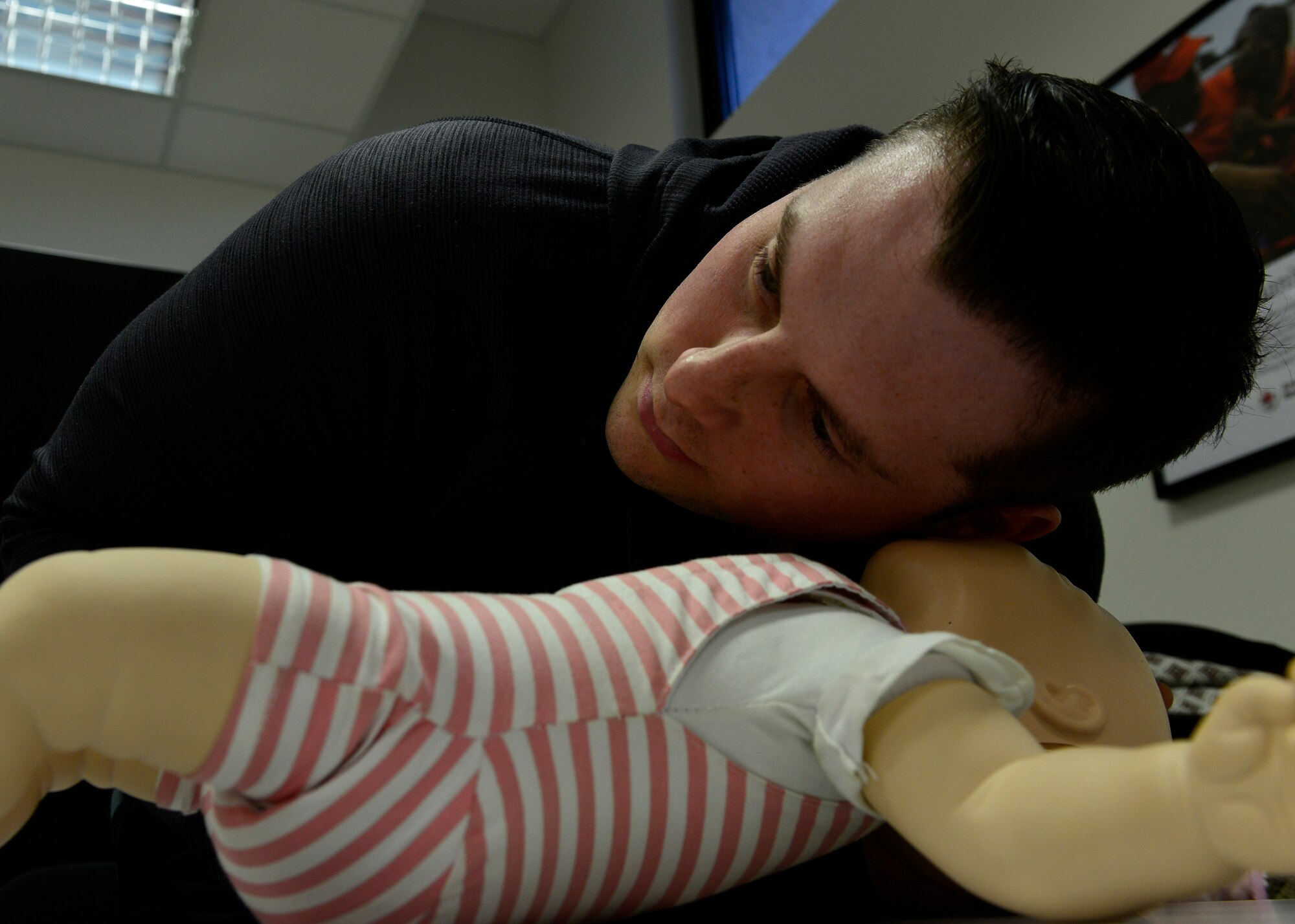 Staff Sgt. Matthew Barker, 31st Maintenance Squadron egress technician, practices airway and breathing checks during an infant cardiopulmonary resuscitation class, March 8, 2016, at Aviano Air Base, Italy. The class was offered by the American Red Cross, and covered tips on how to secure the airway, check for lodged items and resuscitate an infant. (U.S. Air Force photo by Airman 1st Class Cary Smith/Released)