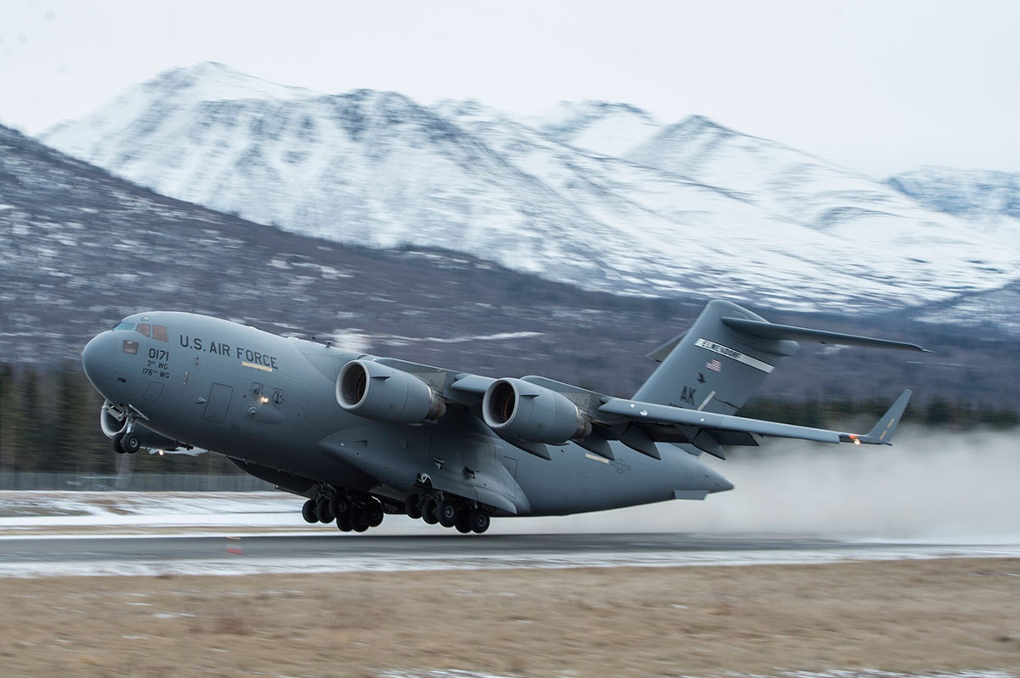 A U.S. Air Force C-17 Globemaster III from the 517th Airlift Squadron takes off from Bryant Army Air Field on Joint Base Elmendorf-Richardson, Alaska,  March 7, 2016.  The event marked the first time a C-17 has taken off from the airfield since its construction in 1958, when the runway was built by the U.S. Army on then-separate Ft. Richardson to support Soldiers in remote areas of Alaska. (U.S. Air Force photo by Senior Airman James Richardson)