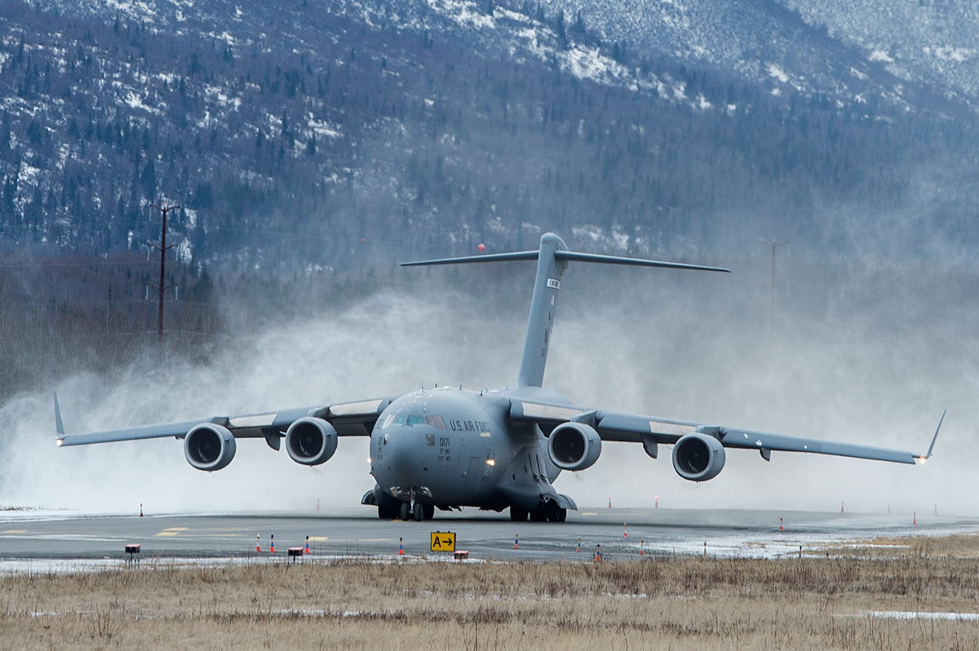 A U.S. Air Force C-17 Globemaster III from the 517th Airlift Squadron takes off from Bryant Army Air Field on Joint Base Elmendorf-Richardson, Alaska,  March 7, 2016.  The event marked the first time a C-17 has taken off from the airfield since its construction in 1958, when the runway was built by the U.S. Army on then-separate Ft. Richardson to support Soldiers in remote areas of Alaska. (U.S. Air Force photo by Senior Airman James Richardson)