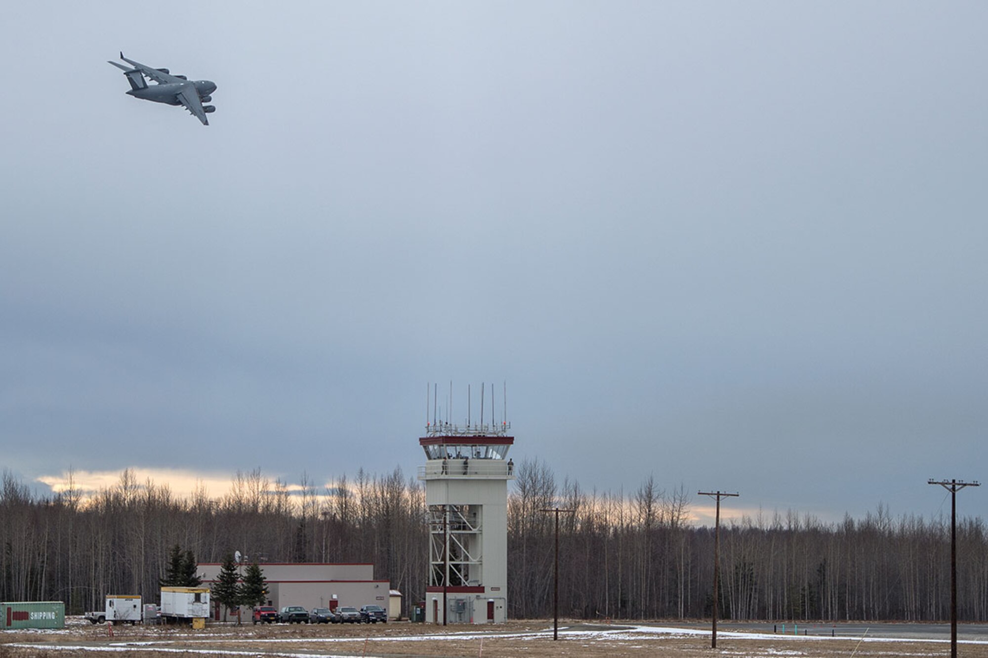 A U.S. Air Force C-17 Globemaster III from the 517th Airlift Squadron does a fly-by prior to landing at Bryant Army Air Field on Joint Base Elmendorf-Richardson, Alaska,  March 7, 2016.  The event marked the first time a C-17 has taken off from the airfield since its construction in 1958, when the runway was built by the U.S. Army on then-separate Ft. Richardson to support Soldiers in remote areas of Alaska. (U.S. Air Force photo by Senior Airman James Richardson)